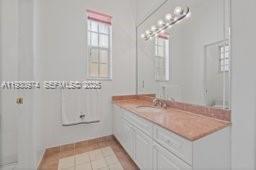 12982 Southwest 27th Street Miami, FL 33175 - Photo 35 of 43 a bathroom with a sink and a mirror