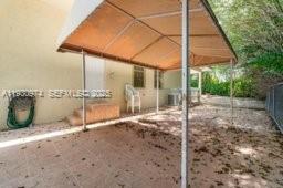12982 Southwest 27th Street Miami, FL 33175 - Photo 39 of 43 a backyard of a house with table and chairs