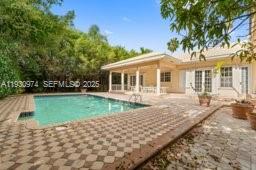 12982 Southwest 27th Street Miami, FL 33175 - Photo 43 of 43 a front view of a house with a yard table and chairs
