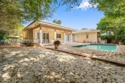 12982 Southwest 27th Street Miami, FL 33175 - Photo 7 of 43 a front view of a house with garden