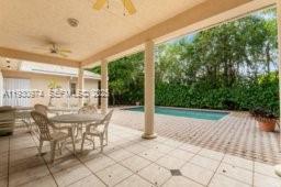 12982 Southwest 27th Street Miami, FL 33175 - Photo 9 of 43 a view of a patio with table and chairs and potted plants