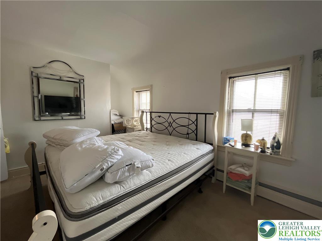 2280 Main Street, Unit 3 Bethlehem, PA 18017 - Photo 8 of 14 a bedroom with a bed window and a flat screen tv