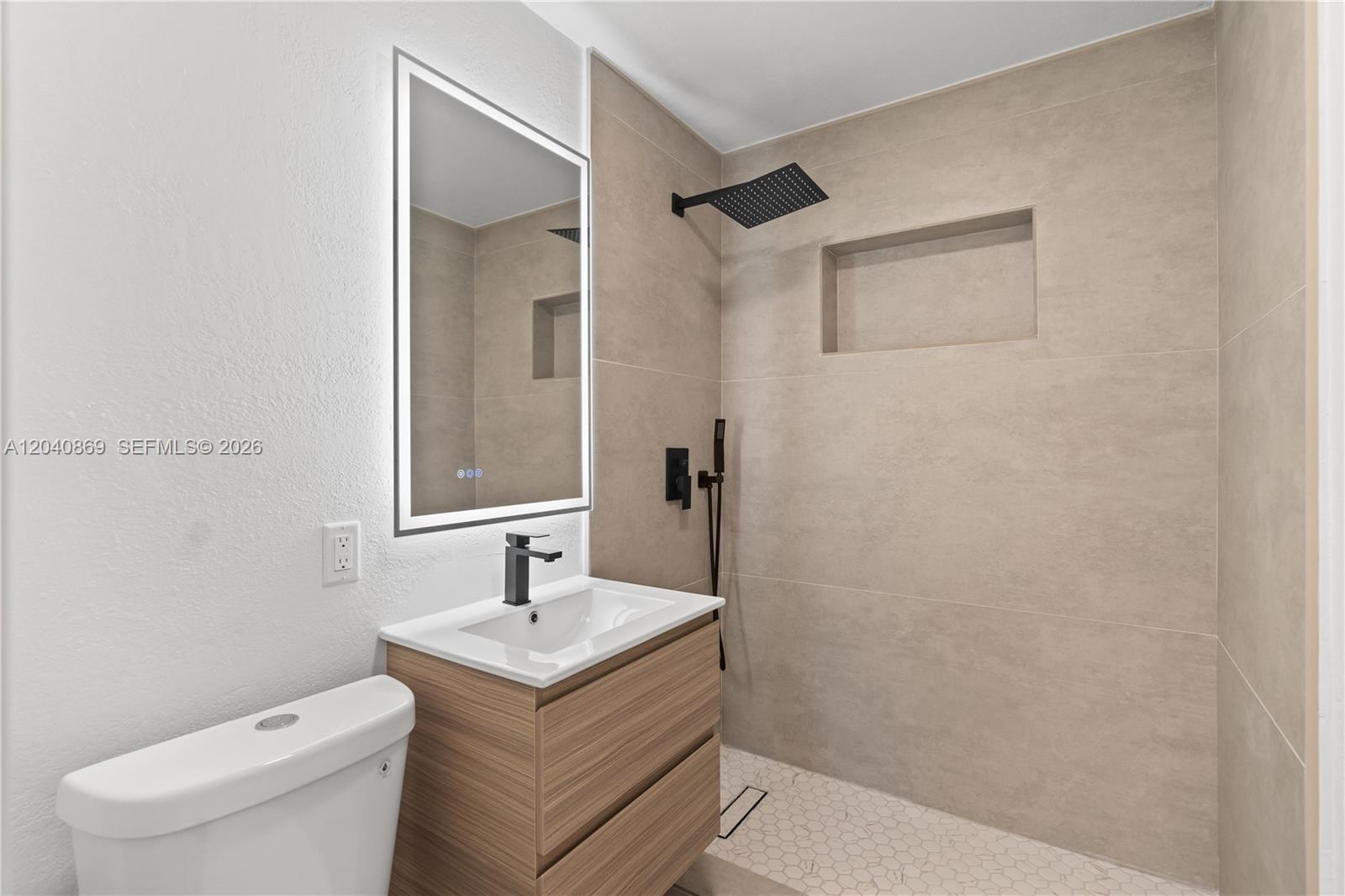 31 West 64th Street Hialeah, FL 33012 - Photo 39 of 49 a bathroom with a granite countertop sink a toilet and a mirror