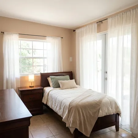 a bedroom with a bed and a window