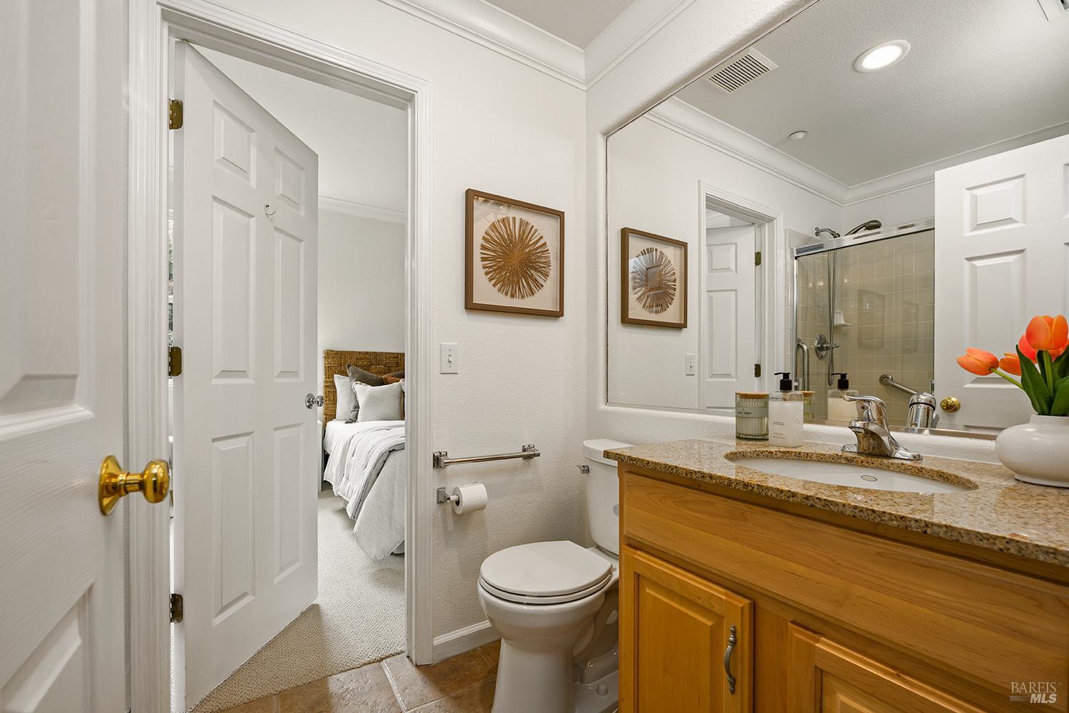 38 Maybeck Street Novato, CA 94949 - Photo 37 of 47 a bathroom with a granite countertop toilet sink and mirror