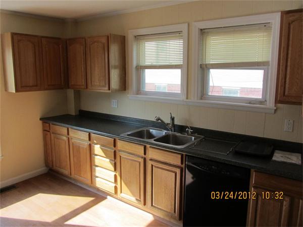 3 Proctor Street, Unit 1 Gloucester, MA 01930 - Photo 6 of 15 a kitchen with granite countertop a sink cabinets and a window