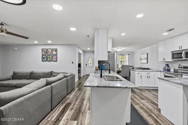 a living room with furniture a fireplace and a flat screen tv