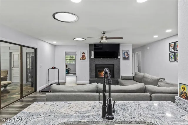 a large kitchen with stainless steel appliances granite countertop a stove refrigerator sink and cabinets