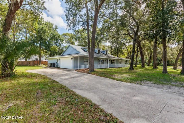 a view of house with outdoor space and tree s