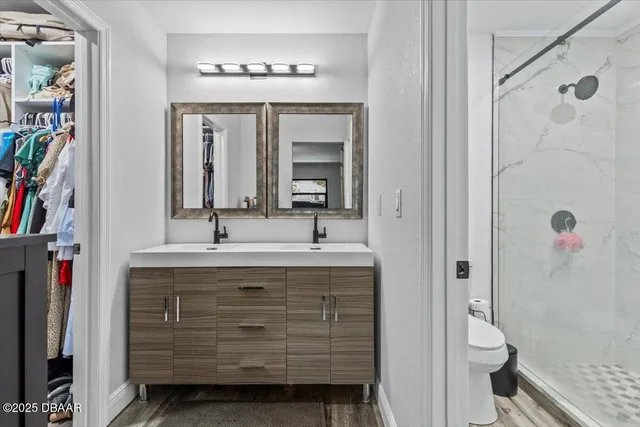 a bathroom with a sink a mirror and a shower
