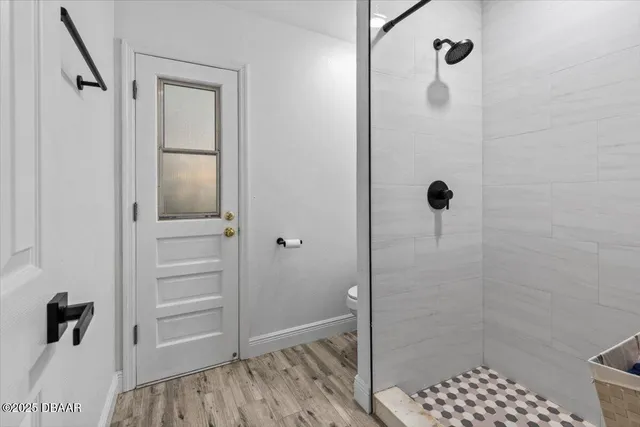 a room with lots of books and a wooden floor