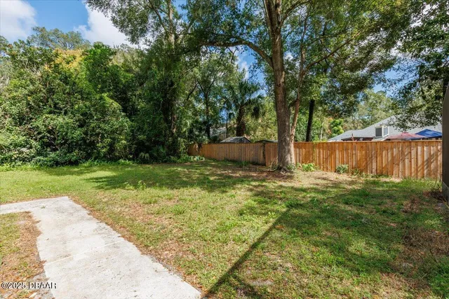 a front view of a house with yard and green space