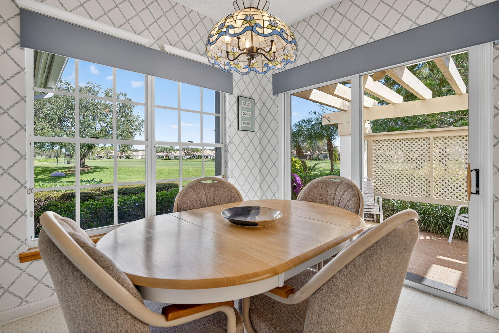 7036 Southeast Winged Foot Drive Stuart, FL 34997 - Photo 24 of 65 a view of a dining room with furniture a chandelier and wooden floor