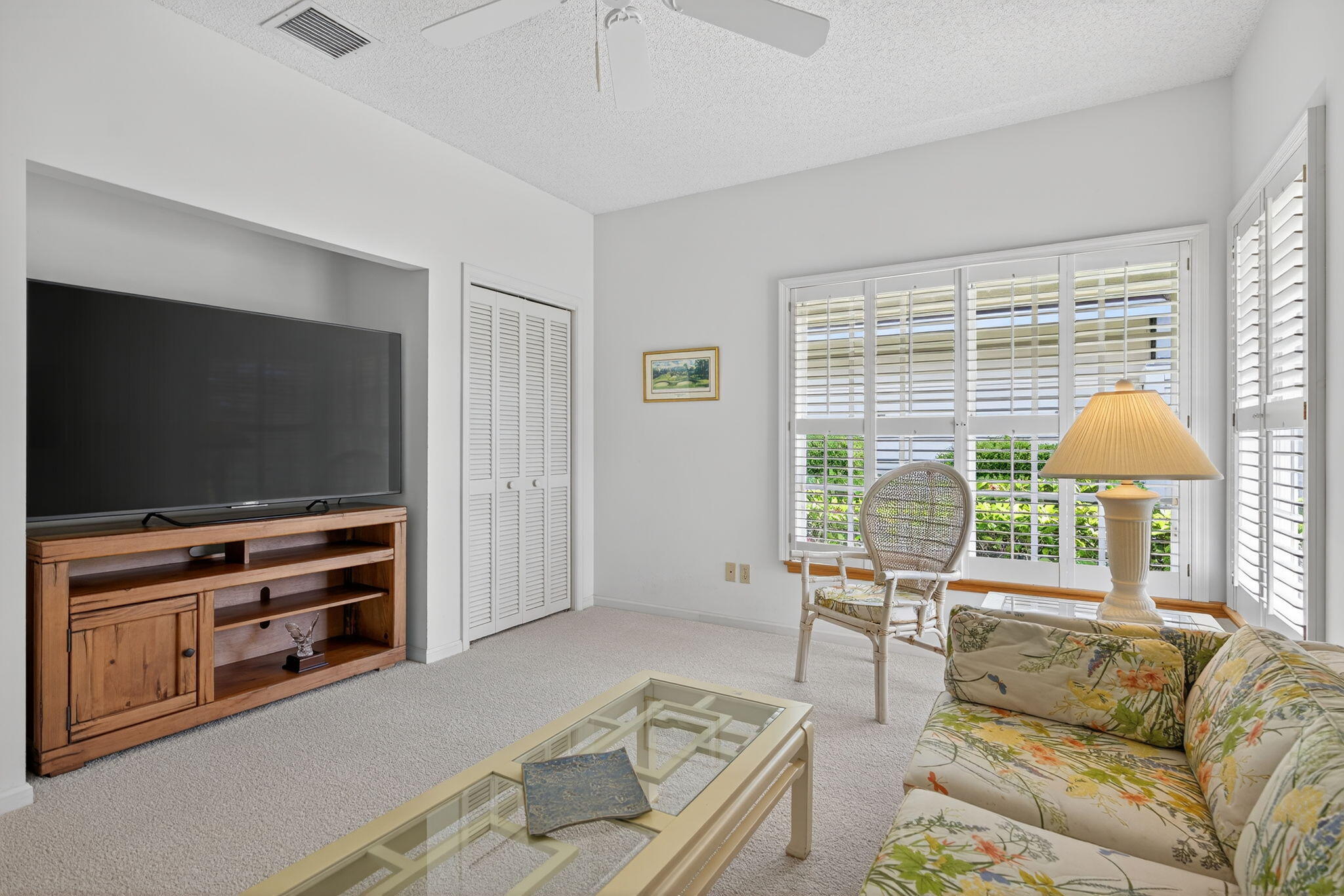 7036 Southeast Winged Foot Drive Stuart, FL 34997 - Photo 32 of 65 a living room with furniture and a flat screen tv