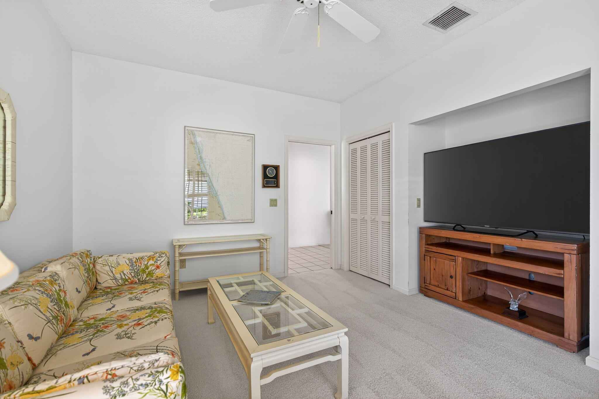 7036 Southeast Winged Foot Drive Stuart, FL 34997 - Photo 34 of 65 a living room with furniture and a flat screen tv
