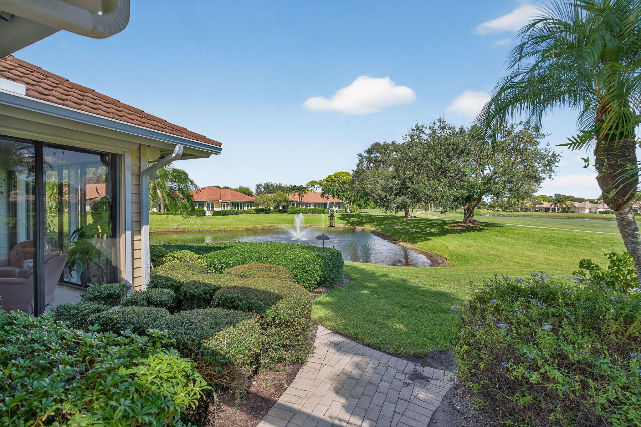 7036 Southeast Winged Foot Drive Stuart, FL 34997 - Photo 39 of 65 a view of a house with a big yard and potted plants