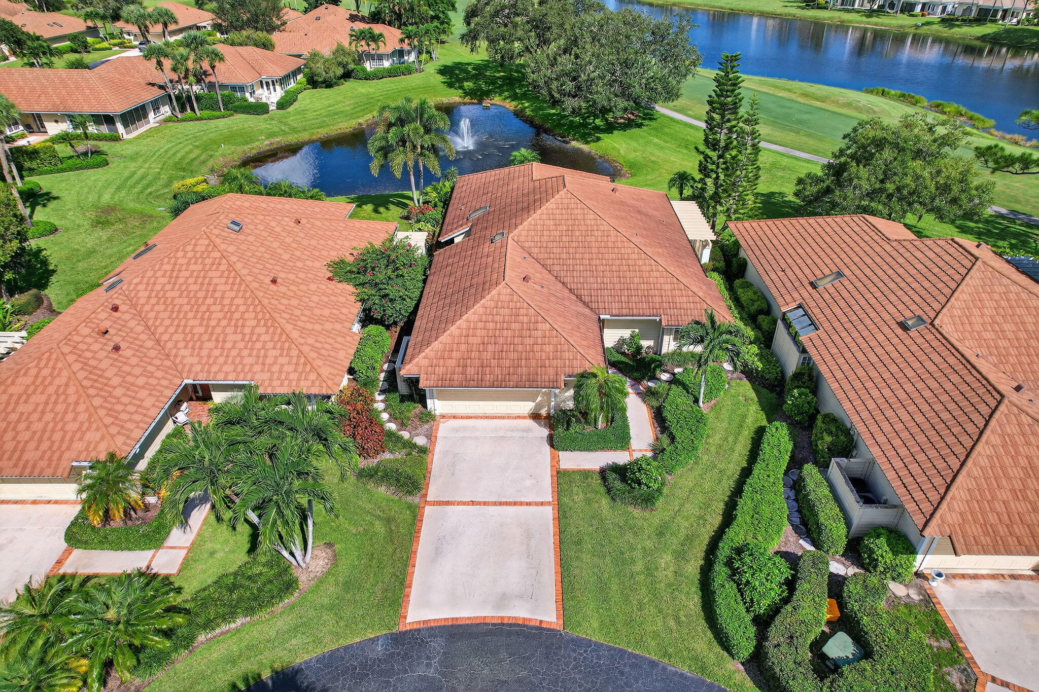 7036 Southeast Winged Foot Drive Stuart, FL 34997 - Photo 5 of 65 an aerial view of a house with a garden and lake view