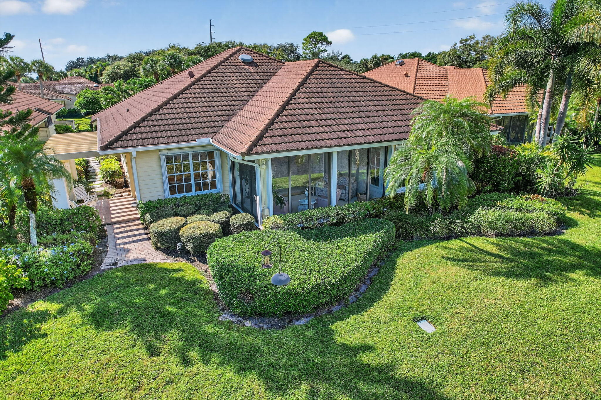 7036 Southeast Winged Foot Drive Stuart, FL 34997 - Photo 6 of 65 a view of a house with a backyard and plants