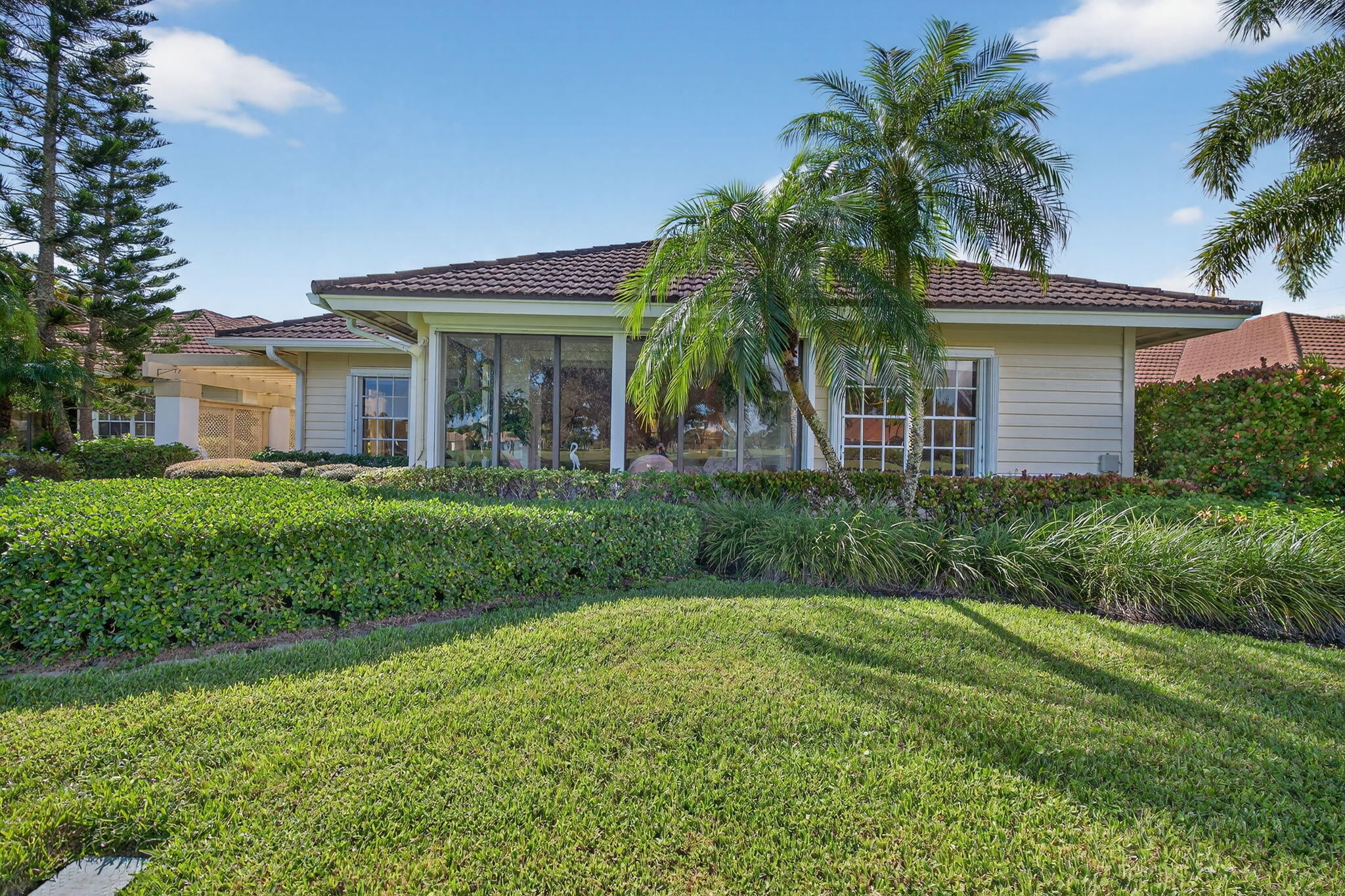 7036 Southeast Winged Foot Drive Stuart, FL 34997 - Photo 7 of 65 a front view of house with yard and green space