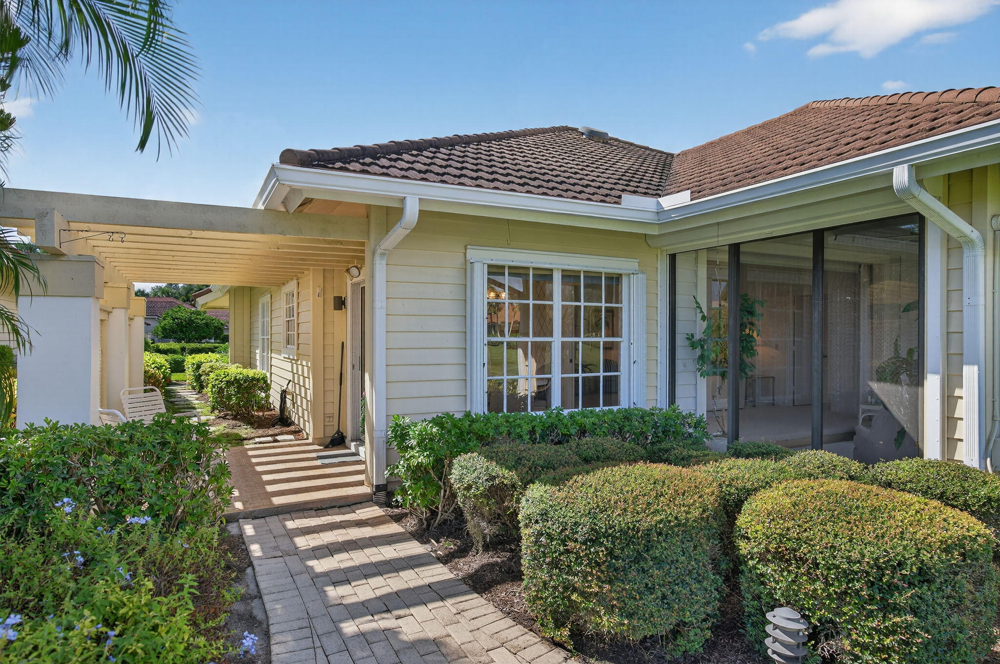 7036 Southeast Winged Foot Drive Stuart, FL 34997 - Photo 8 of 65 a front view of a house with garden