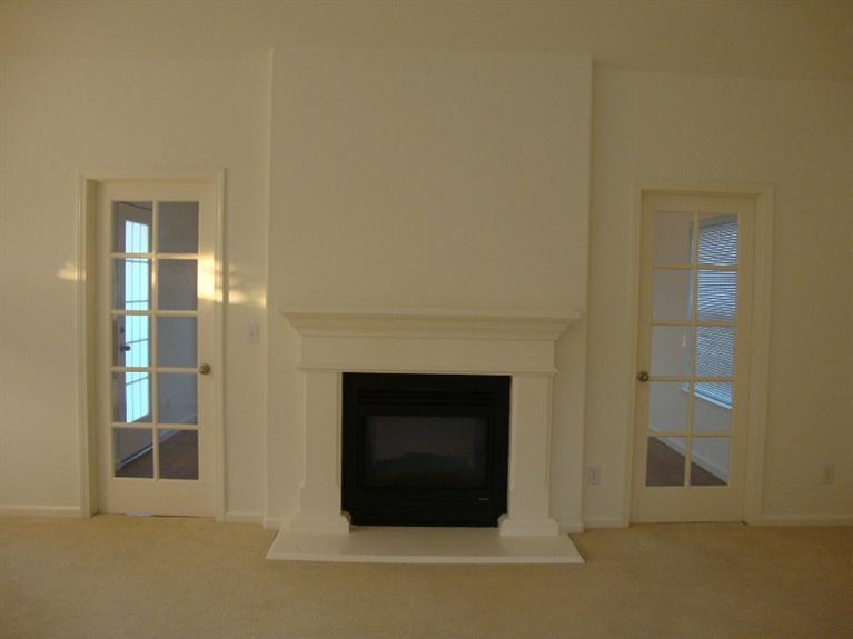 142 East Shoemake Avenue Reedley, CA 93654 - Photo 8 of 10 a living room with a fireplace