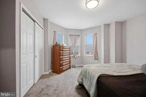a bedroom with a bed and a closet