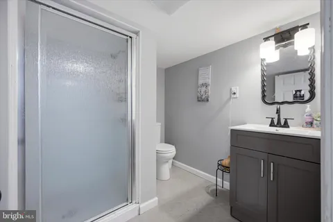 a bathroom with a toilet a sink and mirror