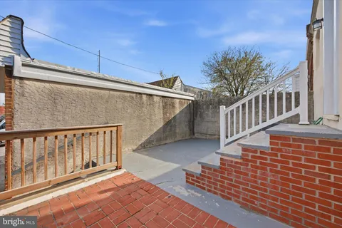 a view of a balcony with wooden floor and fence