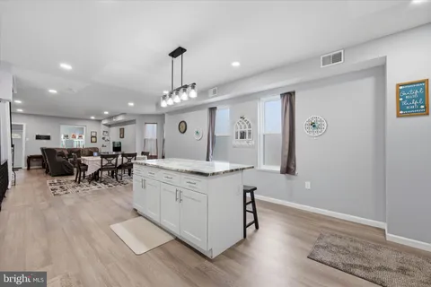 a kitchen with stainless steel appliances granite countertop a lot of counter space and wooden floor