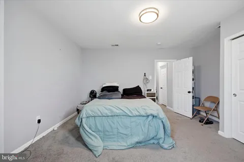 a bedroom with a bed and gym equipment