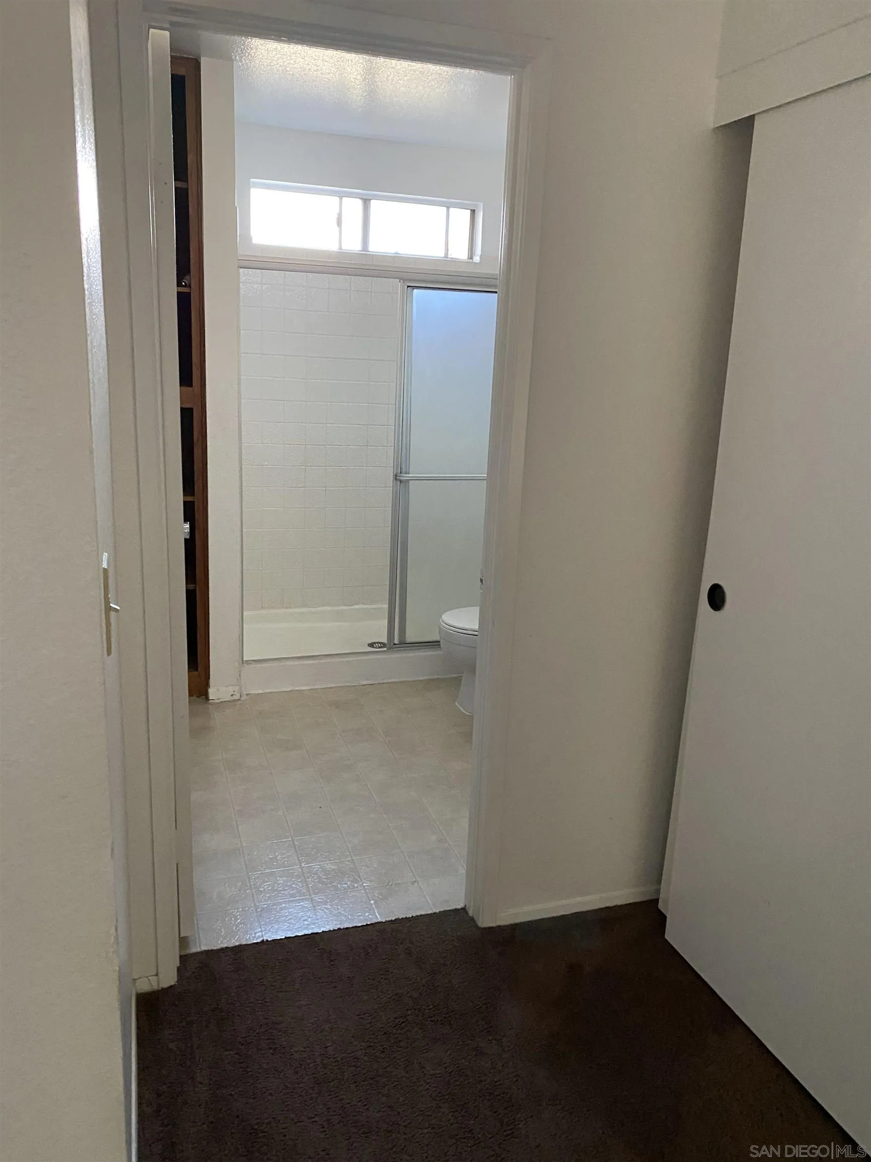 514 Jamacha Road, Unit 24J El Cajon, CA 92019 - Photo 24 of 32 an empty room with wooden floor mirror and door