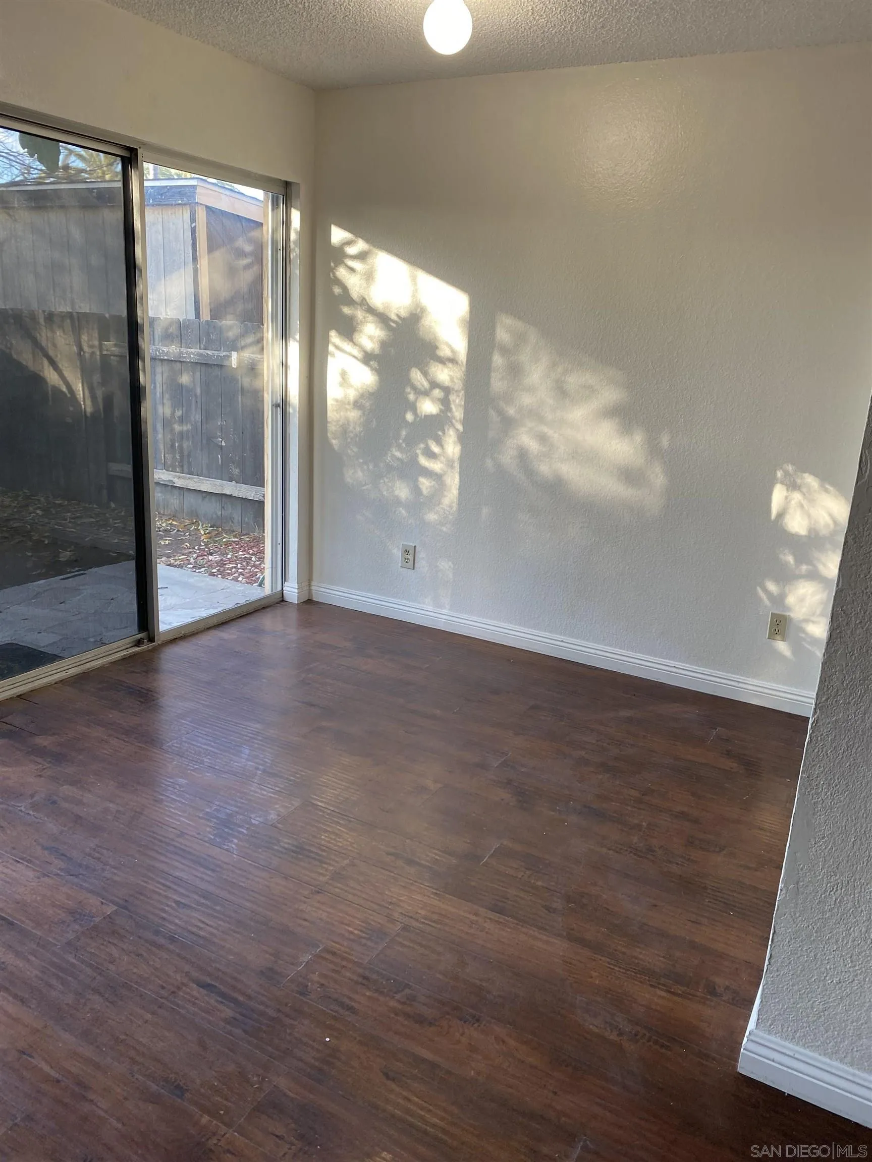 514 Jamacha Road, Unit 24J El Cajon, CA 92019 - Photo 7 of 32 a view of an empty room with wooden floor and a window