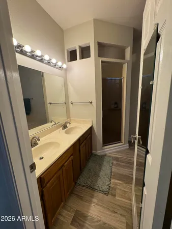 a bathroom with a double vanity sink and a mirror