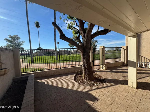 a view of a porch with a floor to ceiling window and a potted plant