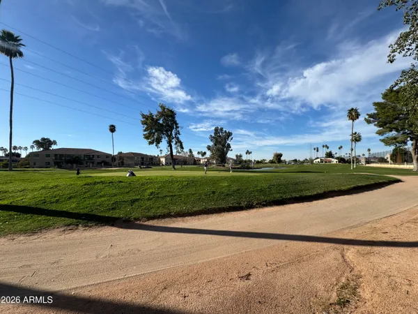 a view of a golf course with a road