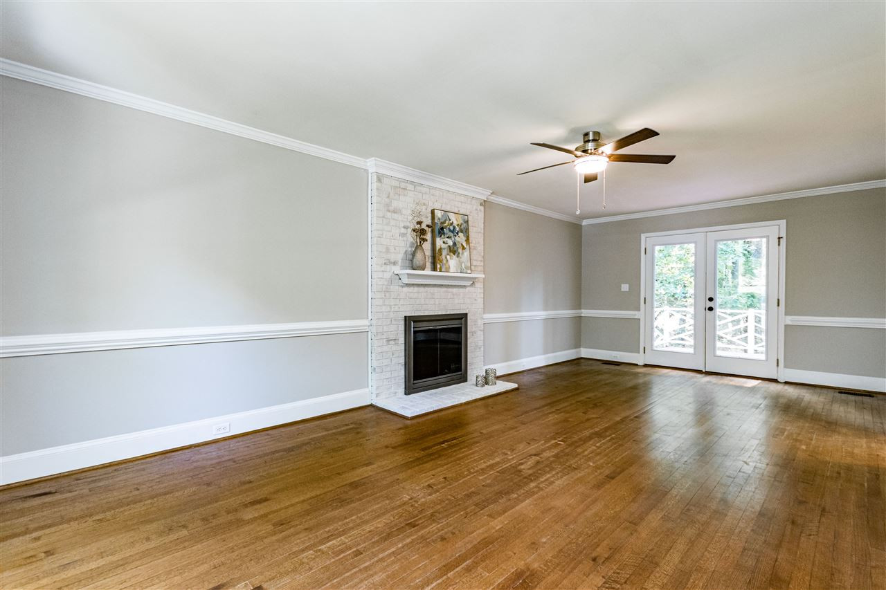 7301 Quinby Court Raleigh, NC 27613 - Photo 11 of 23 Lime washed brick wood burning fireplace and hardwood floors. Huge room. Family Room