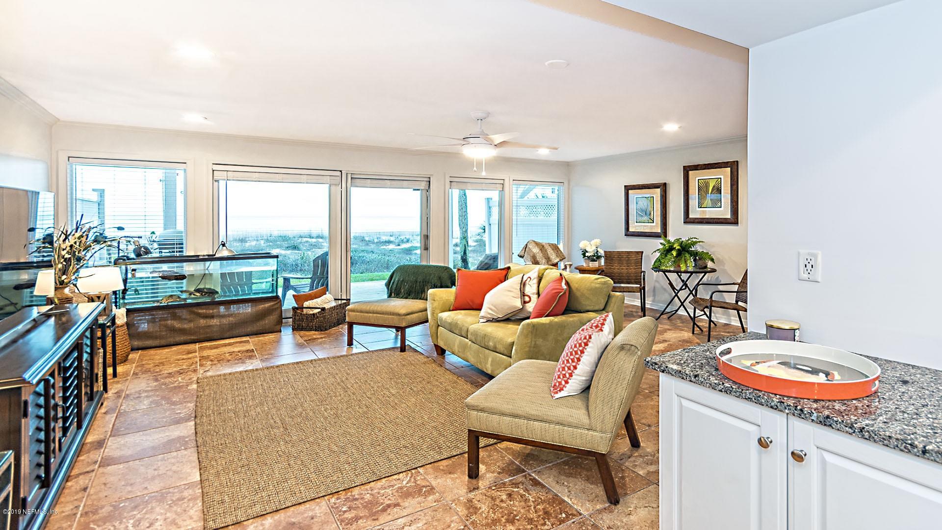 2233 Seminole Road, Unit 15 Atlantic Beach, FL 32233 - Photo 47 of 48 a living room with furniture and a floor to ceiling window