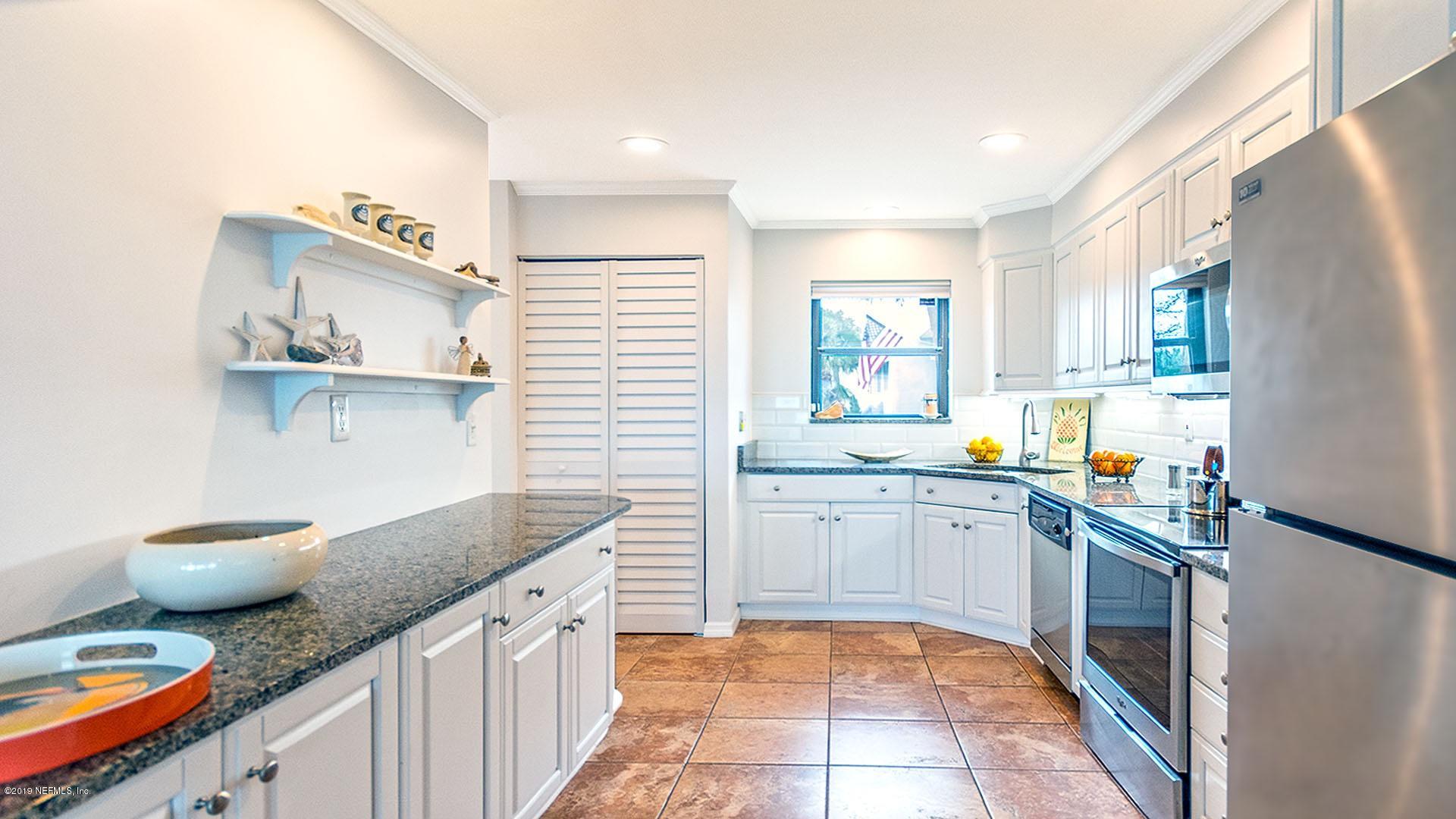 2233 Seminole Road, Unit 15 Atlantic Beach, FL 32233 - Photo 13 of 48 a kitchen with stainless steel appliances granite countertop a sink stove and cabinets