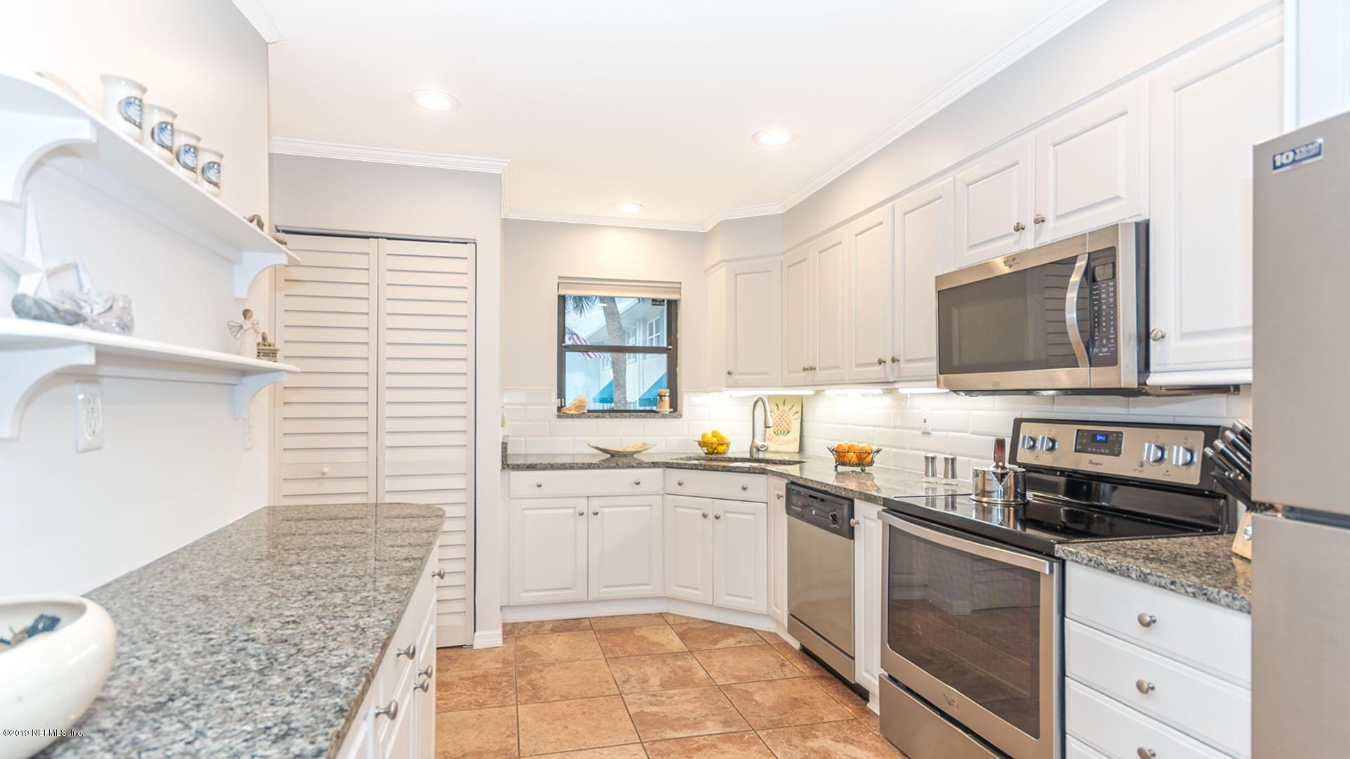 2233 Seminole Road, Unit 15 Atlantic Beach, FL 32233 - Photo 14 of 48 a kitchen with a sink stove top oven and cabinets