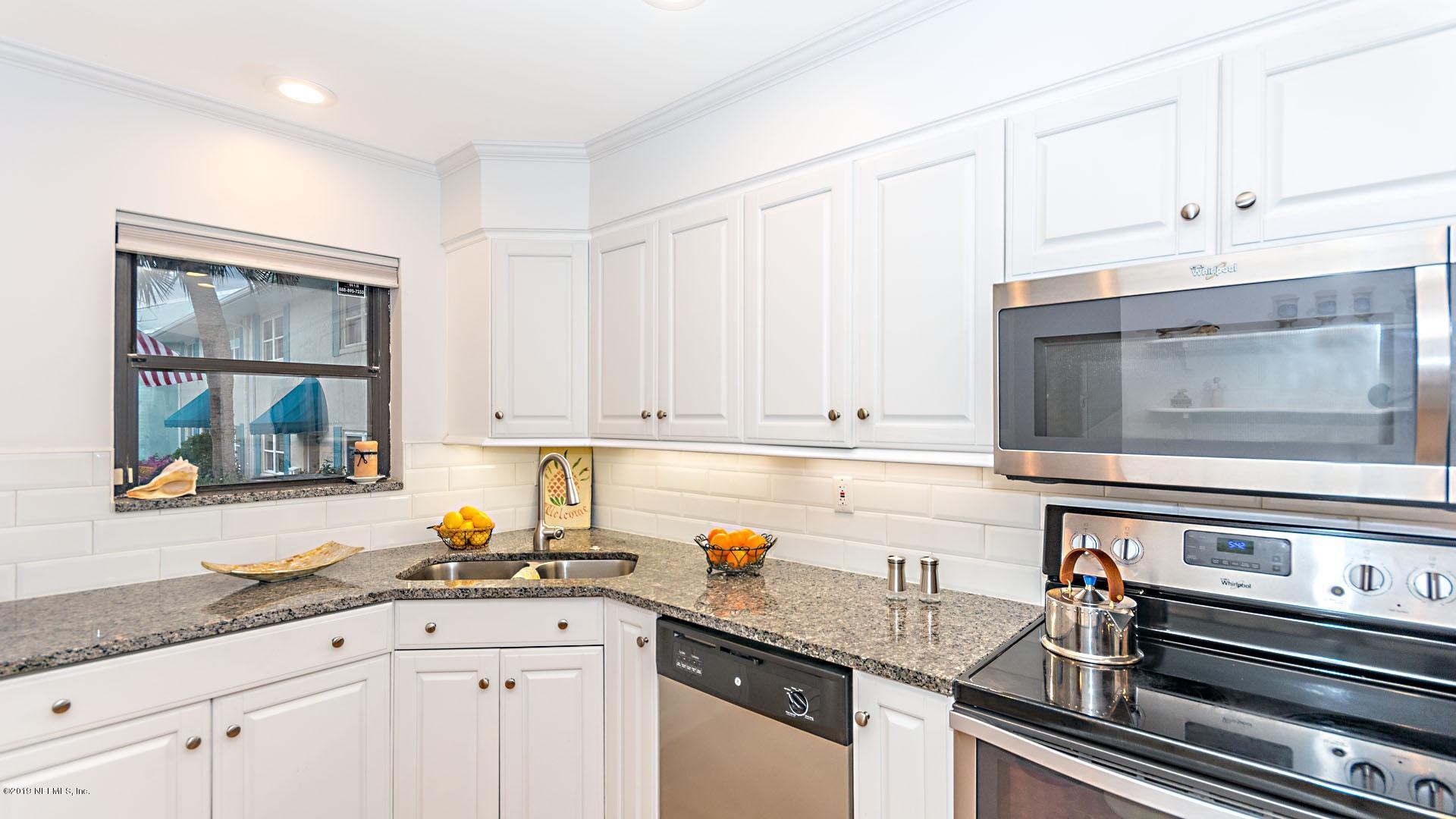 2233 Seminole Road, Unit 15 Atlantic Beach, FL 32233 - Photo 16 of 48 a kitchen with granite countertop white cabinets and white appliances