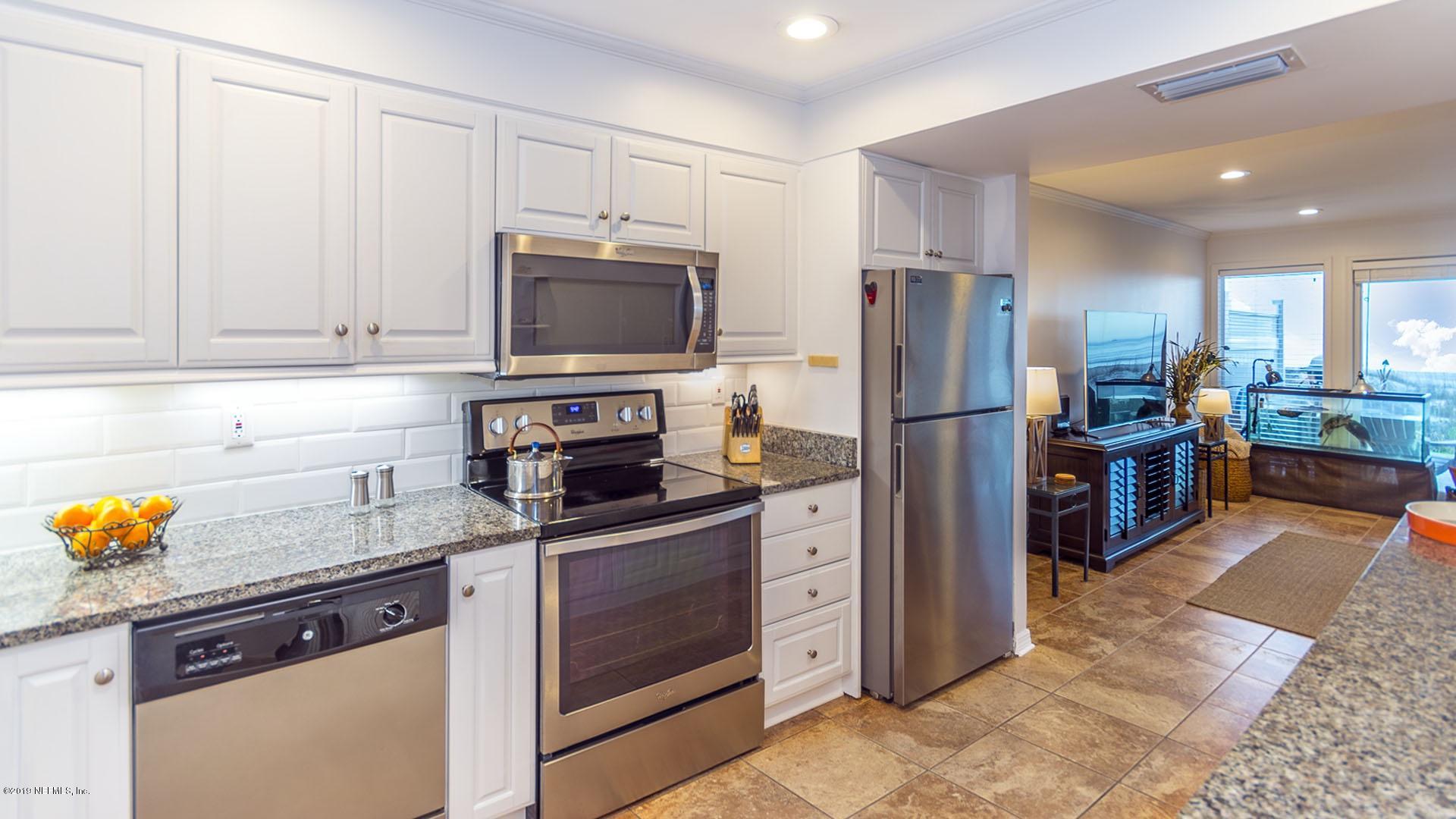 2233 Seminole Road, Unit 15 Atlantic Beach, FL 32233 - Photo 17 of 48 a kitchen with stainless steel appliances granite countertop a refrigerator stove and sink
