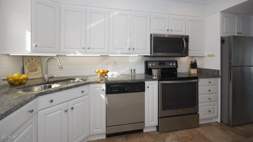2233 Seminole Road, Unit 15 Atlantic Beach, FL 32233 - Photo 18 of 48 a kitchen with stainless steel appliances granite countertop white cabinets and a refrigerator