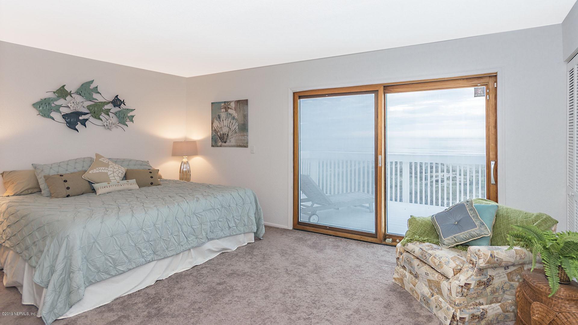 2233 Seminole Road, Unit 15 Atlantic Beach, FL 32233 - Photo 19 of 48 a spacious bedroom with a bed and a couch