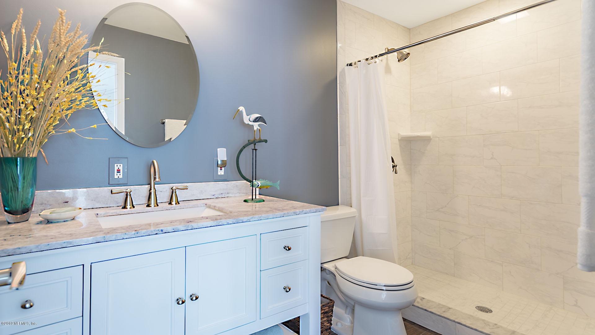 2233 Seminole Road, Unit 15 Atlantic Beach, FL 32233 - Photo 22 of 48 a bathroom with a granite countertop sink toilet and a mirror