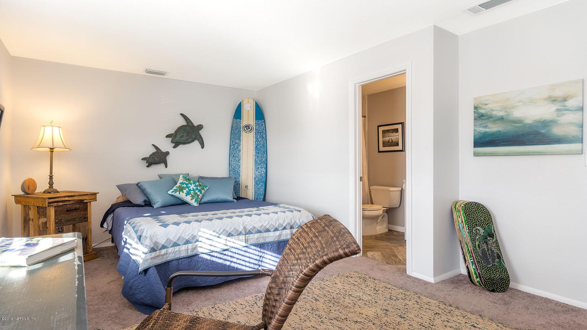 2233 Seminole Road, Unit 15 Atlantic Beach, FL 32233 - Photo 26 of 48 a bedroom with bed and wooden floor