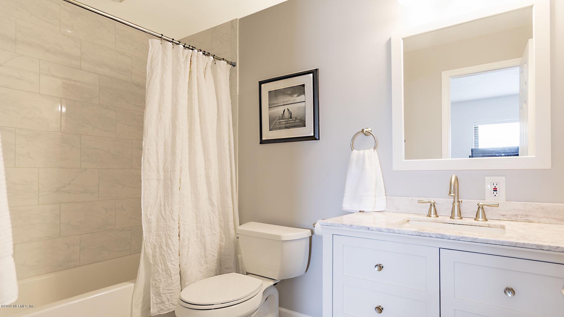 2233 Seminole Road, Unit 15 Atlantic Beach, FL 32233 - Photo 27 of 48 a bathroom with a toilet a sink and a mirror