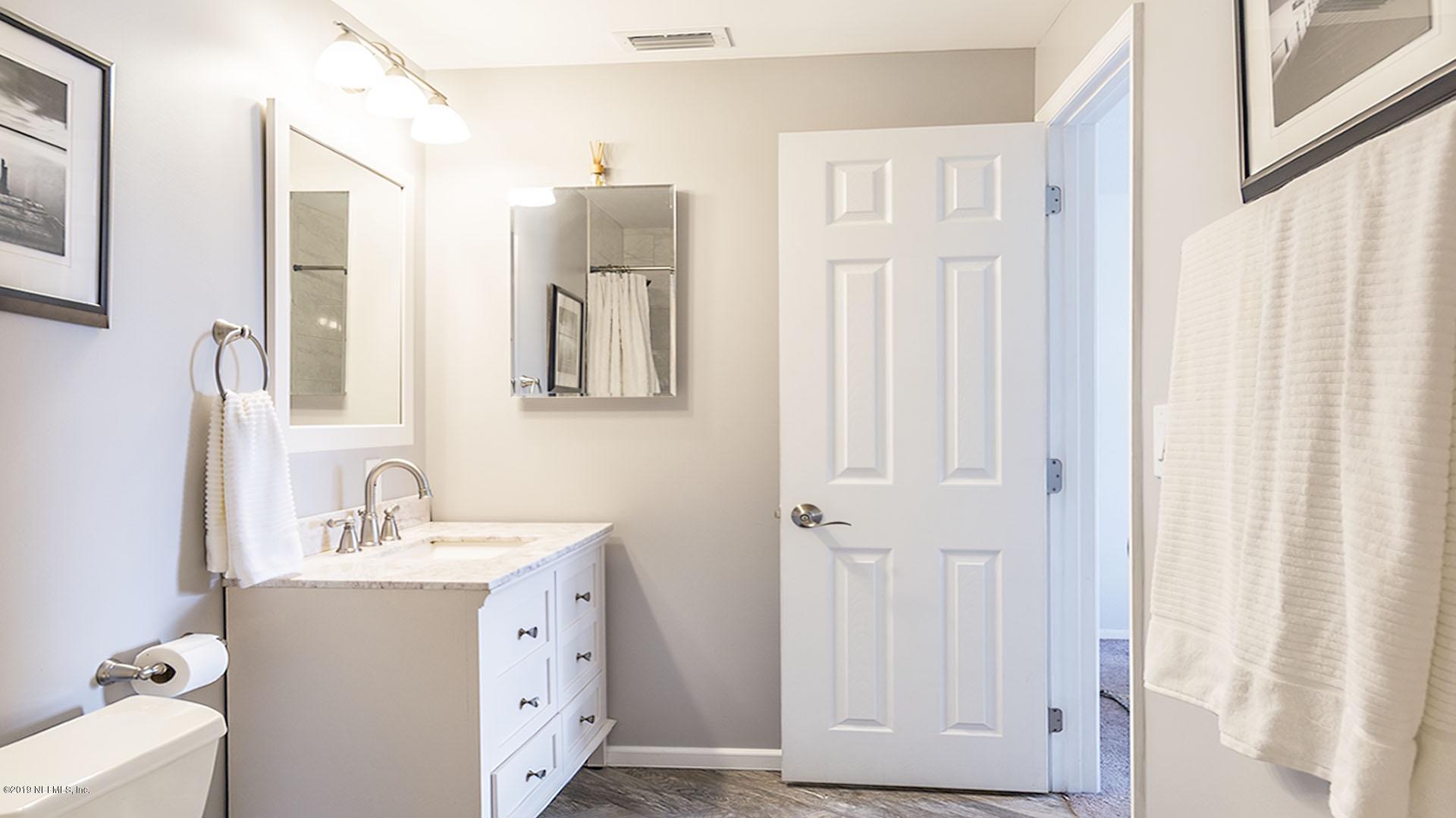 2233 Seminole Road, Unit 15 Atlantic Beach, FL 32233 - Photo 28 of 48 a bathroom with a double vanity sink and mirror