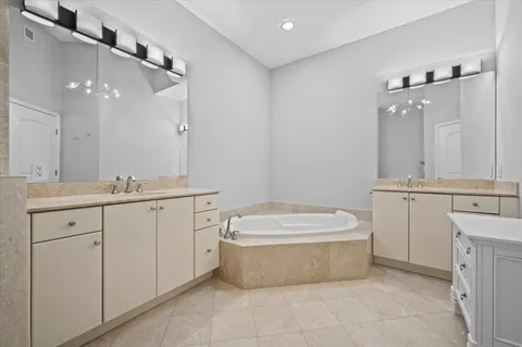 a spacious bathroom with a bathtub sink and mirror