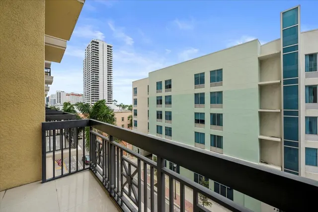 a view of a balcony with wooden floor and fence
