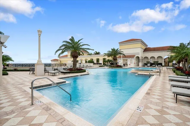 a view of an ocean with boats and trees in the background